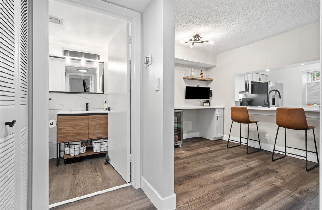 4620 West McNab Road, Unit B1 Pompano Beach, FL 33069 - Photo 14 of 36 a en suite bathroom with a sink and a mirror