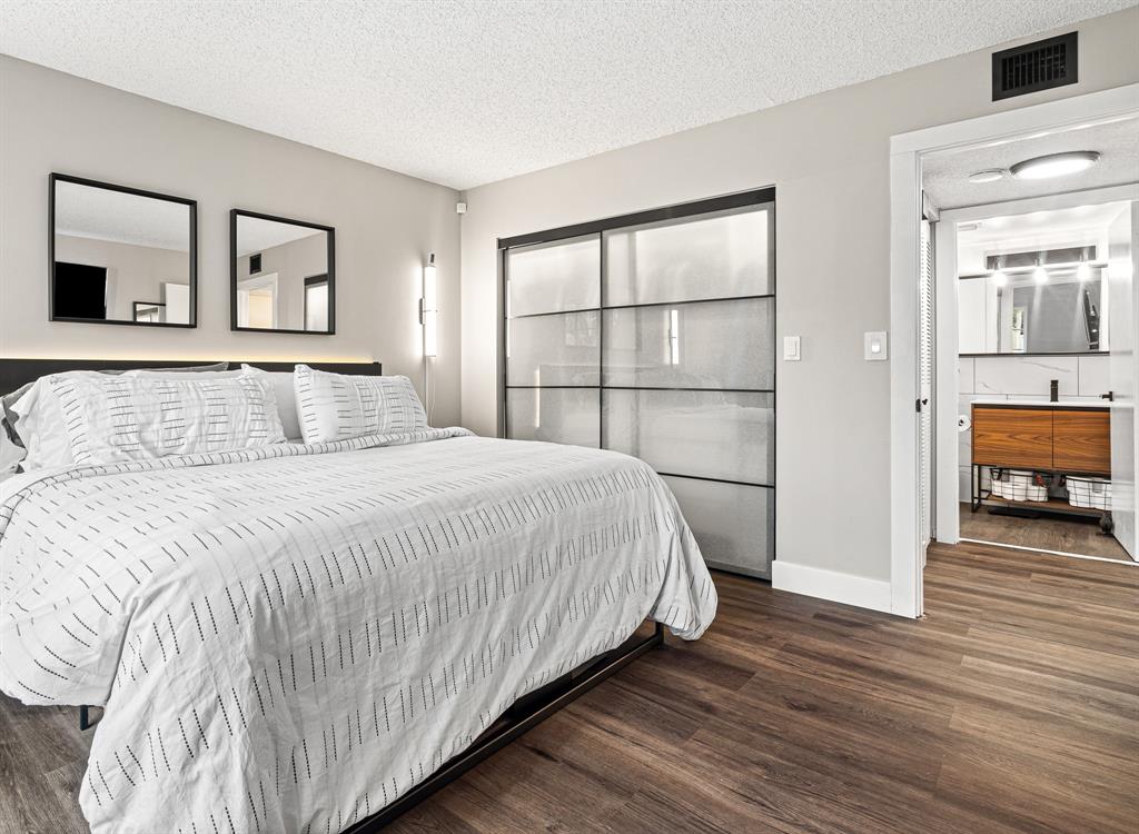 4620 West McNab Road, Unit B1 Pompano Beach, FL 33069 - Photo 23 of 36 a bedroom with a bed and a large window