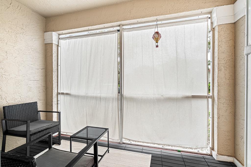 4620 West McNab Road, Unit B1 Pompano Beach, FL 33069 - Photo 27 of 36 a bathroom with a shower and a chair