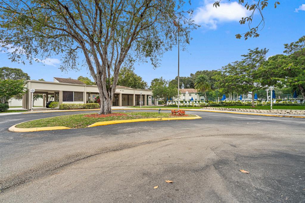 4620 West McNab Road, Unit B1 Pompano Beach, FL 33069 - Photo 35 of 36 a view of pool and trees in the background