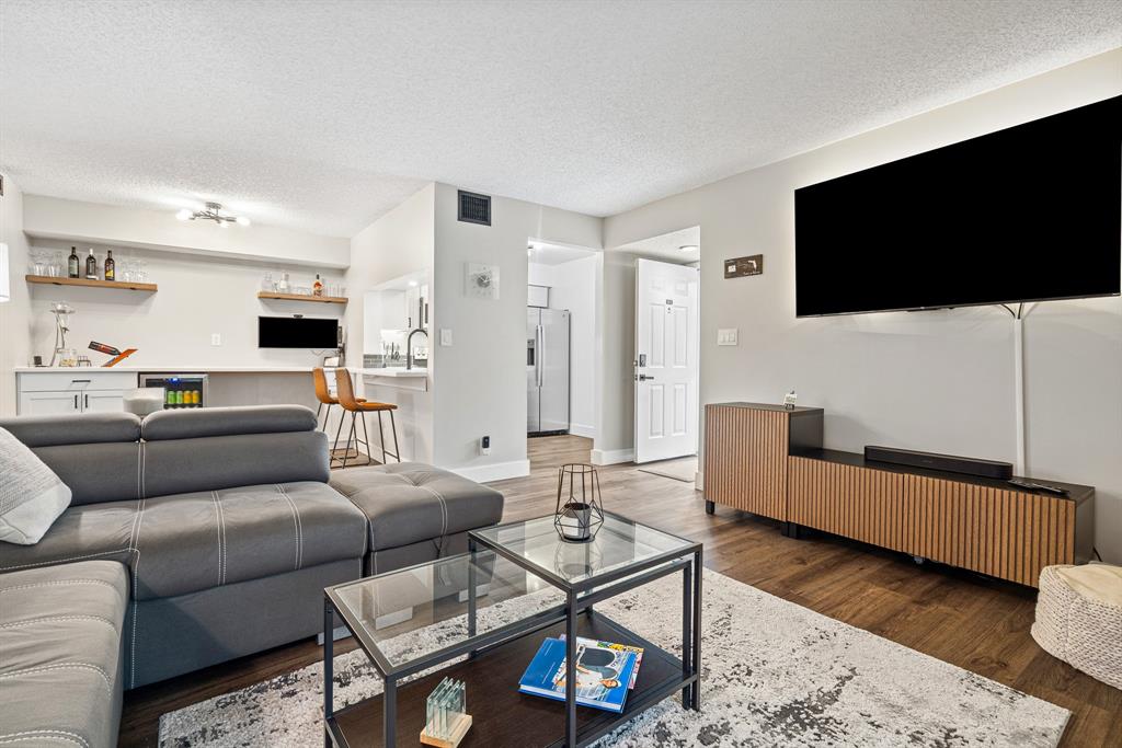 4620 West McNab Road, Unit B1 Pompano Beach, FL 33069 - Photo 6 of 36 a living room with furniture and a flat screen tv