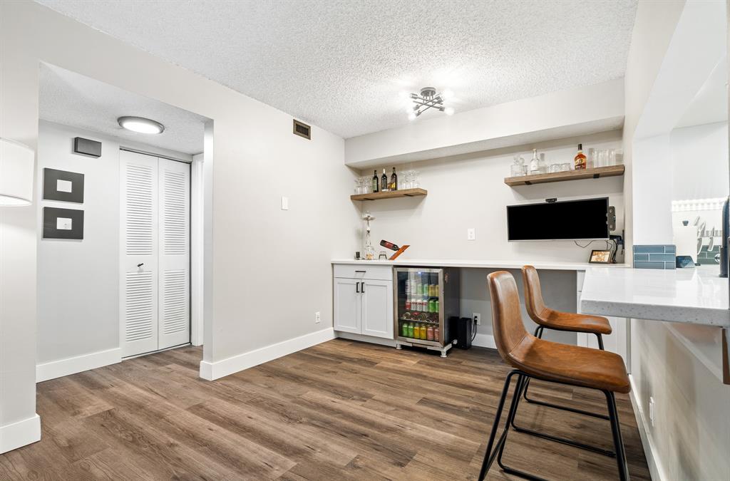 4620 West McNab Road, Unit B1 Pompano Beach, FL 33069 - Photo 9 of 36 a view of a workspace with furniture and flat screen tv