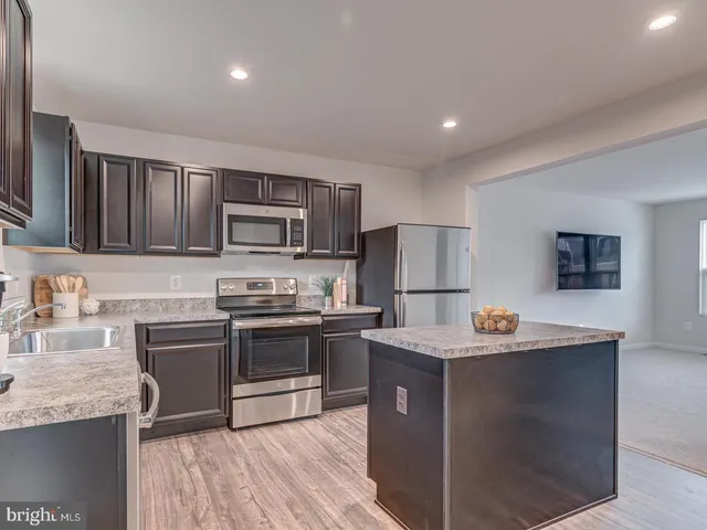 a large kitchen with lots of counter space and stainless steel appliances