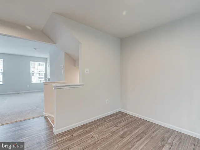 a view of a livingroom with furniture and a kitchen