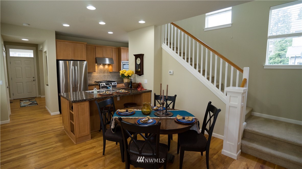 662 Lyons Avenue Northeast Renton, WA 98059 - Photo 12 of 28 a view of a dining room with furniture window and wooden floor