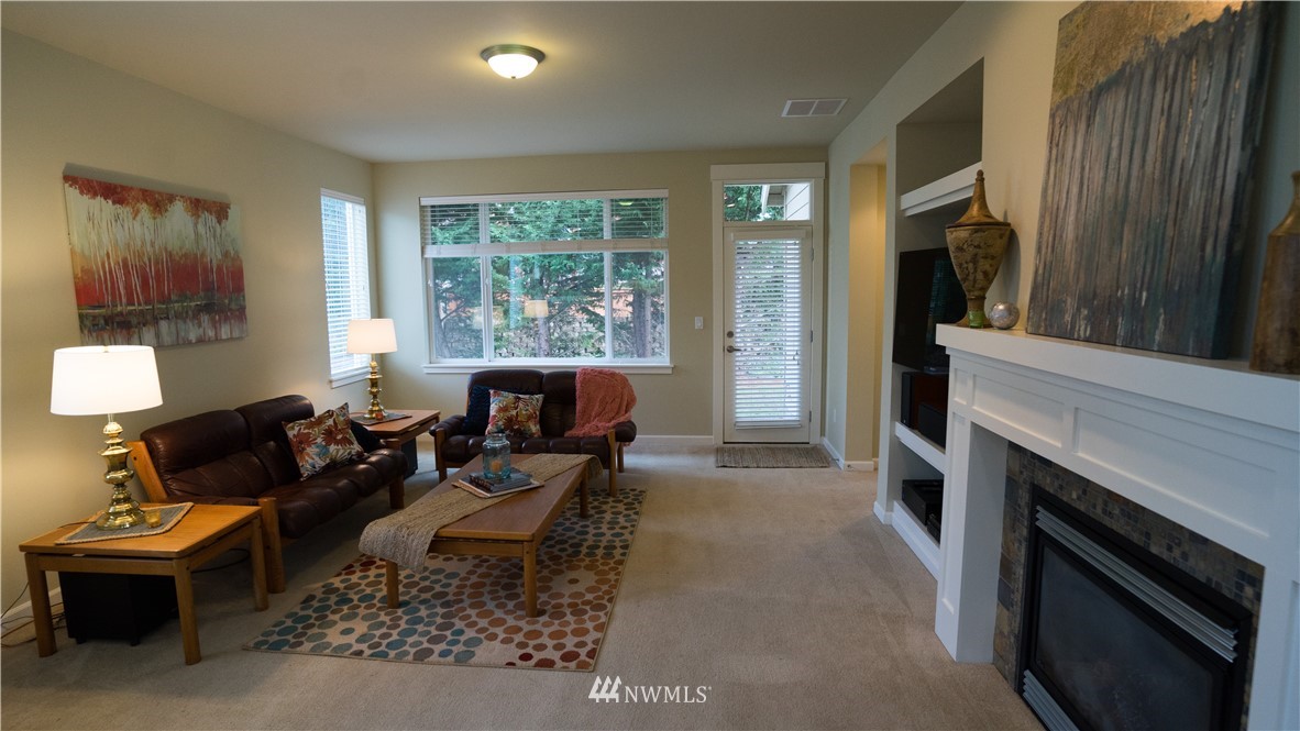 662 Lyons Avenue Northeast Renton, WA 98059 - Photo 14 of 28 a living room with furniture a flat screen tv and a fireplace