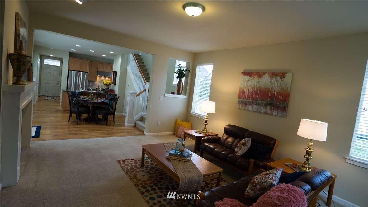 662 Lyons Avenue Northeast Renton, WA 98059 - Photo 15 of 28 a living room with furniture and a chandelier