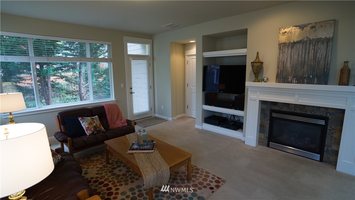 662 Lyons Avenue Northeast Renton, WA 98059 - Photo 16 of 28 a living room with furniture and a fireplace