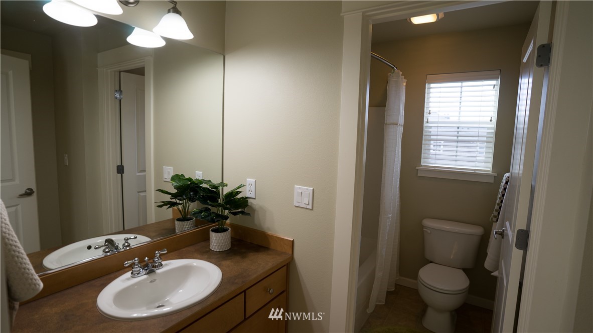 662 Lyons Avenue Northeast Renton, WA 98059 - Photo 20 of 28 a bathroom with a sink toilet and a mirror