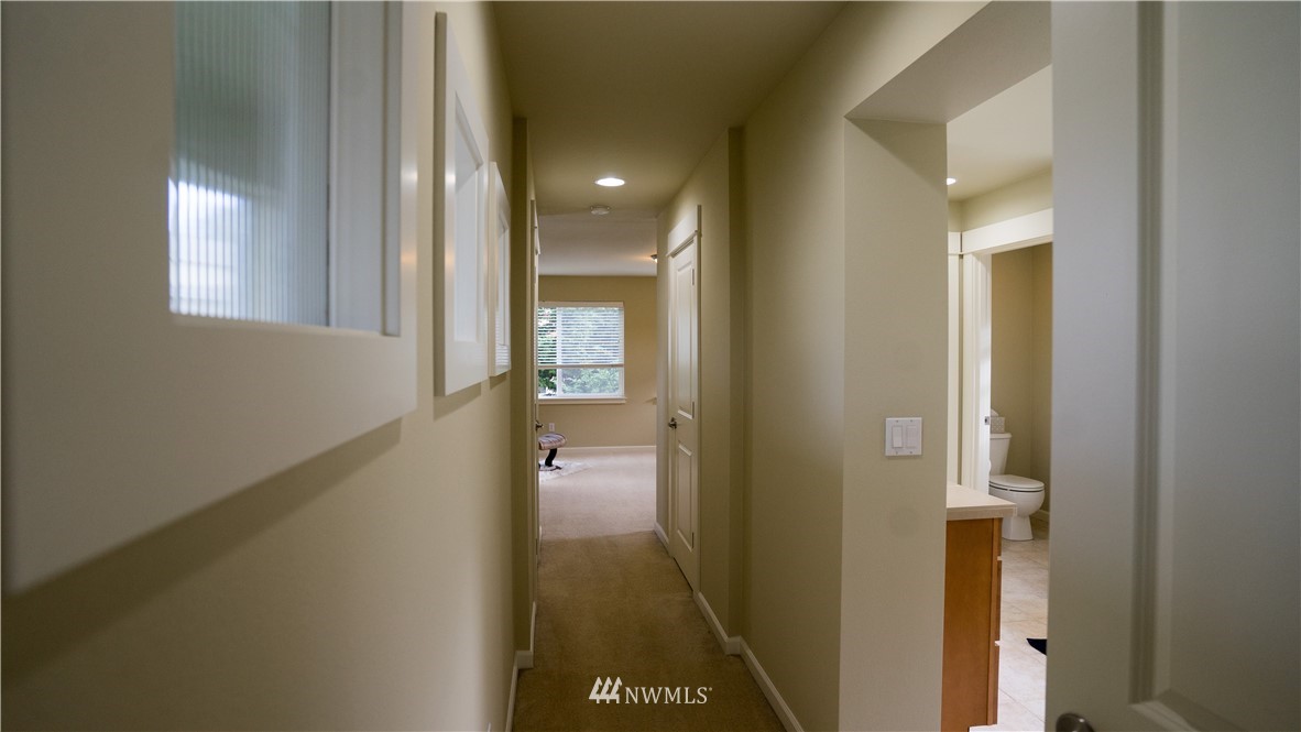 662 Lyons Avenue Northeast Renton, WA 98059 - Photo 22 of 28 a view of a hallway with a livingroom and a bathroom with sink