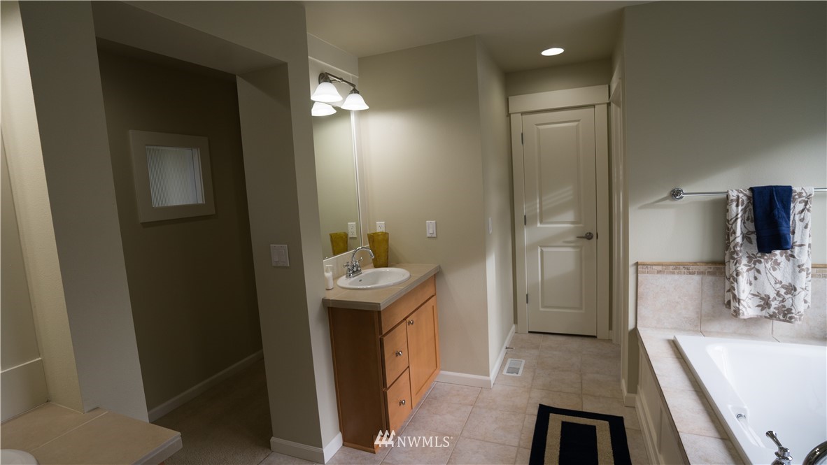 662 Lyons Avenue Northeast Renton, WA 98059 - Photo 23 of 28 a bathroom with a sink and mirror