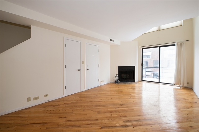 944 West Grace Street, Unit E202 Chicago, IL 60613 - Photo 3 of 10 a view of empty room with wooden floor and fan