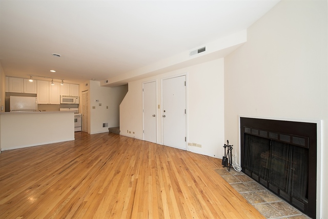 944 West Grace Street, Unit E202 Chicago, IL 60613 - Photo 5 of 10 a view of empty room with wooden floor and fan
