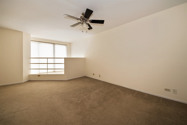 944 West Grace Street, Unit E202 Chicago, IL 60613 - Photo 7 of 10 an empty room with a window