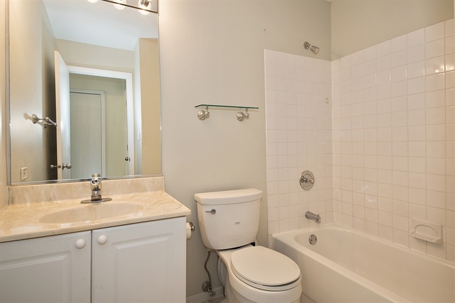 944 West Grace Street, Unit E202 Chicago, IL 60613 - Photo 10 of 10 a bathroom with a sink toilet and shower