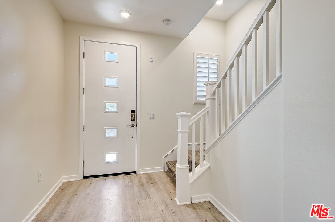 202 Paramount Irvine, CA 92618 - Photo 13 of 32 a view of entryway with stairs and wooden floor