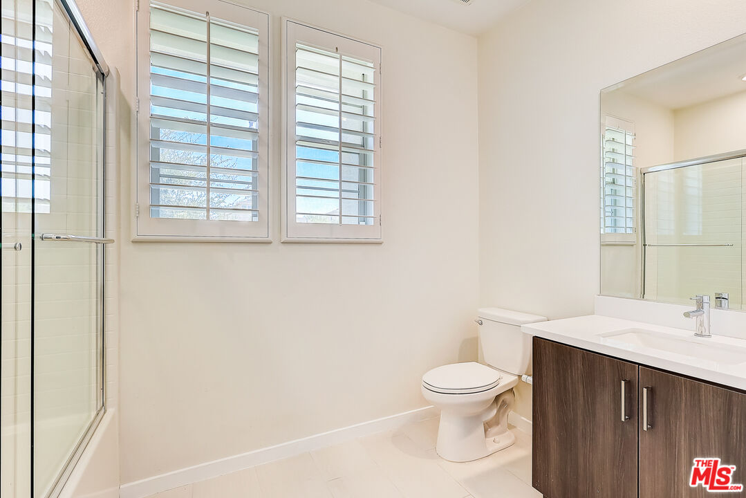 202 Paramount Irvine, CA 92618 - Photo 16 of 32 a bathroom with a toilet a sink and a window