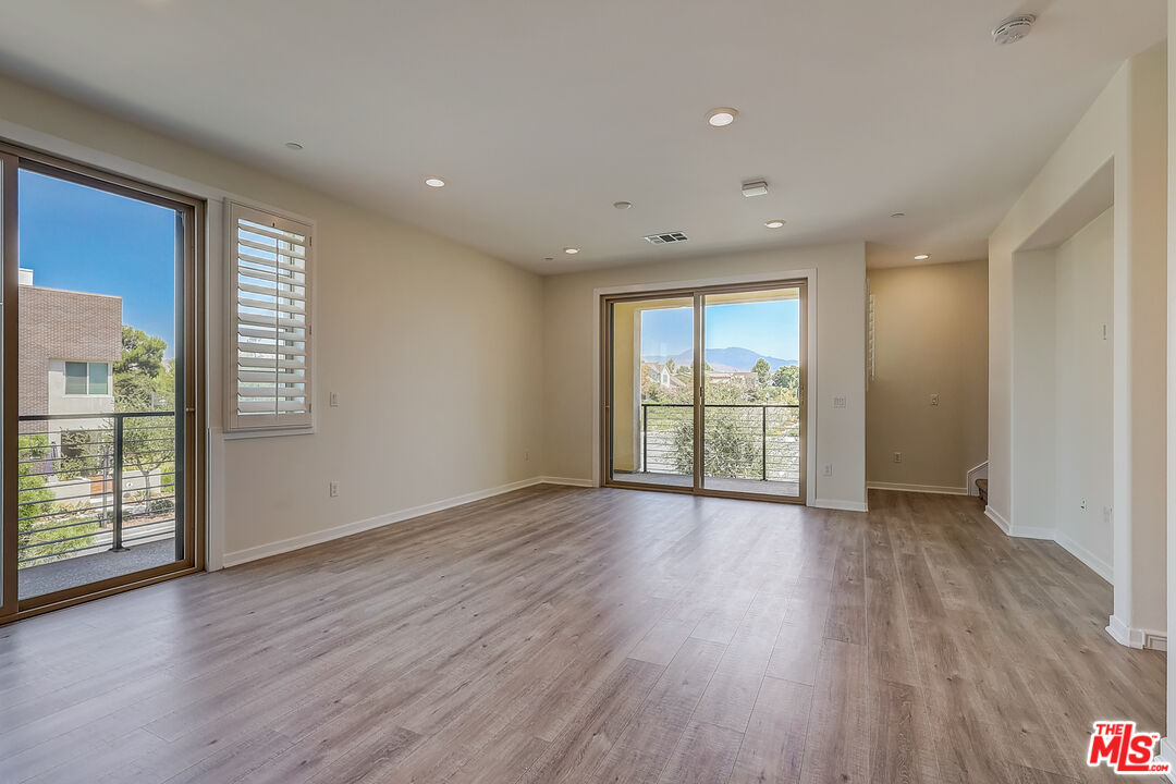 202 Paramount Irvine, CA 92618 - Photo 5 of 32 a view of an empty room with wooden floor and a window
