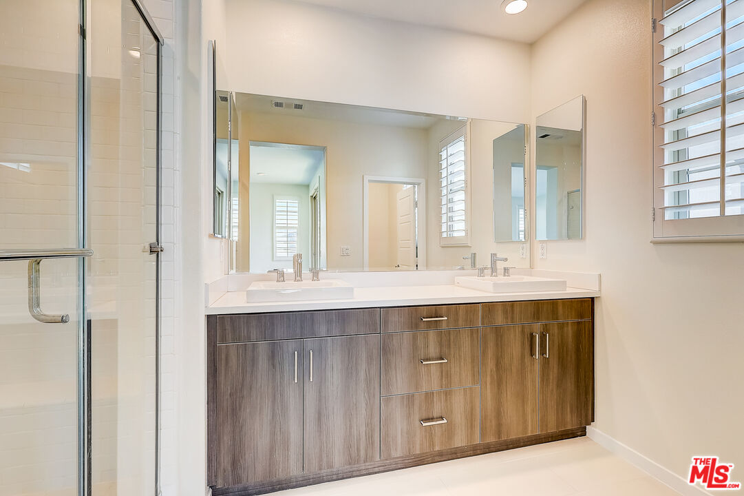 202 Paramount Irvine, CA 92618 - Photo 6 of 32 a bathroom with a sink double vanity and a mirror