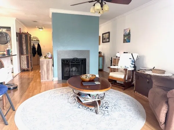 a living room with furniture a fireplace and a table