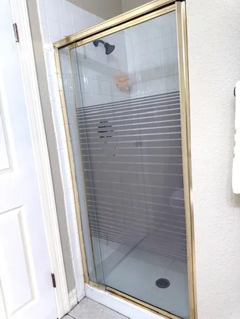 a bathroom with a glass shower door
