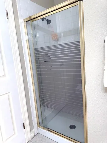 a bathroom with a glass shower door