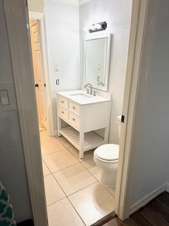 a bathroom with a sink toilet and mirror