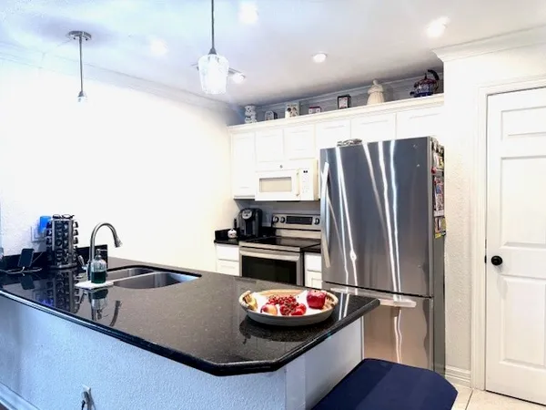 a kitchen with refrigerator and stove