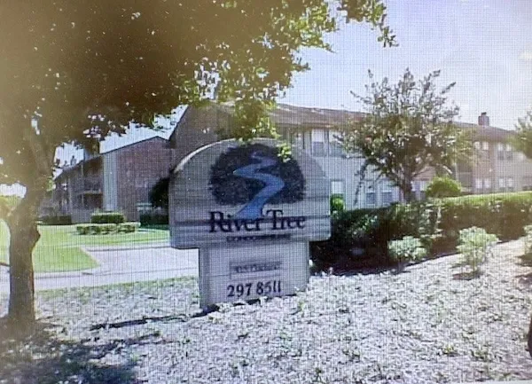 a sign that is sitting in front of a big yard