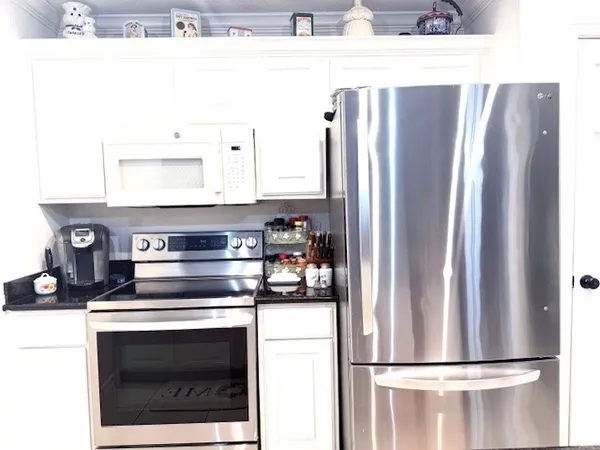 a kitchen with stainless steel appliances a refrigerator and a stove