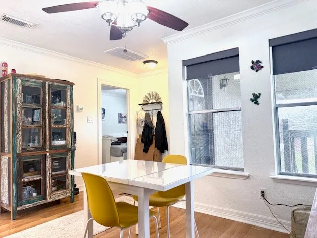 a view of a dining room with furniture and wooden floor
