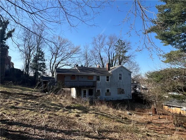 a view of a house with a yard covered with snow