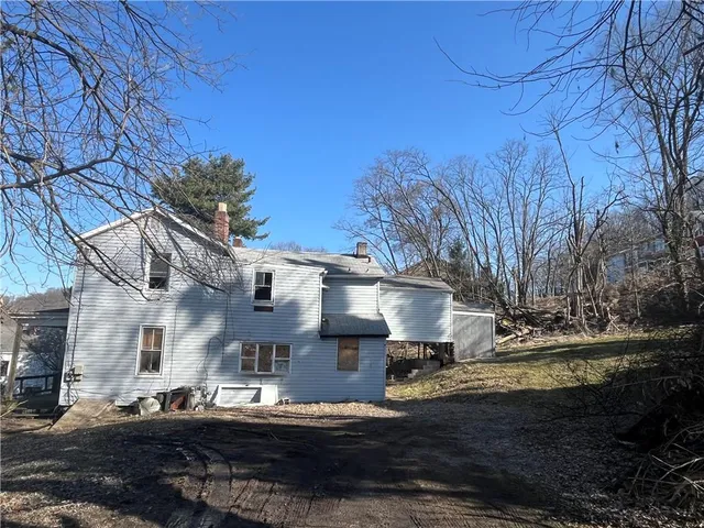 a view of a yard with wooden fence