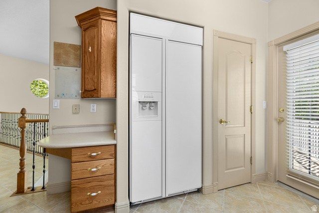 389 North Main Street St. George, UT 84770 - Photo 25 of 44 Kitchen with paneled built in refrigerator, wood finish cabinets, light countertops, and light tile patterned floors