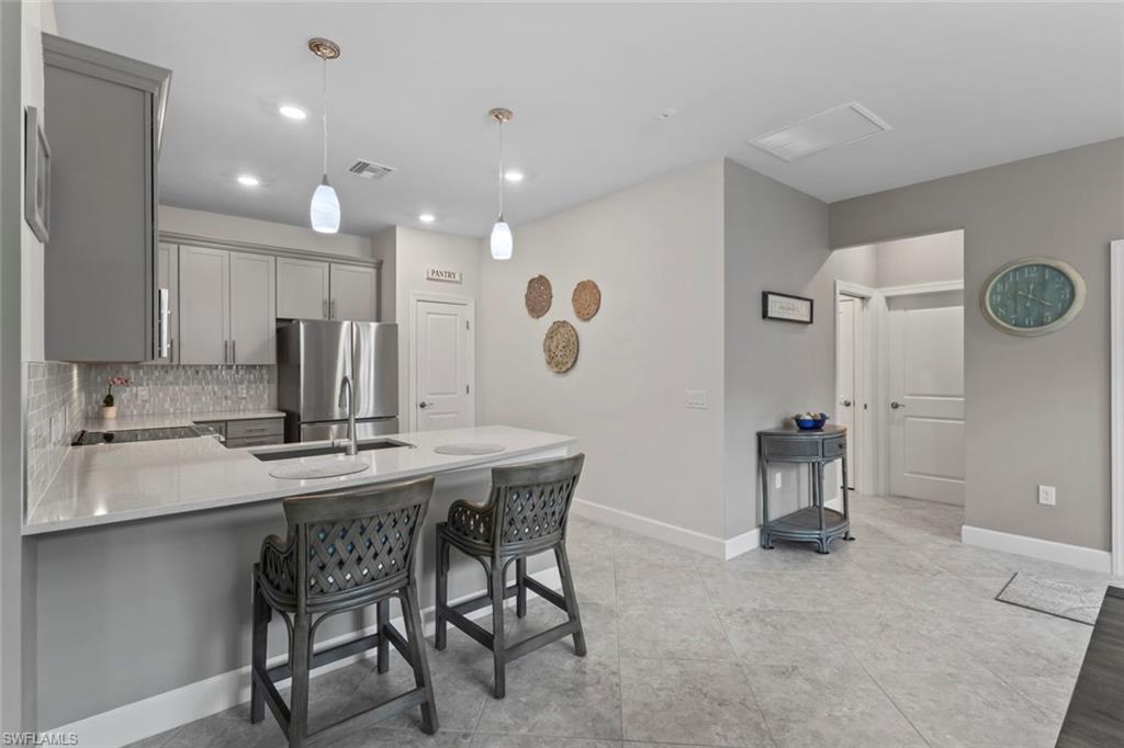 5825 Mayflower Way Ave Maria, FL 34142 - Photo 11 of 50 a view of kitchen with cabinets and window