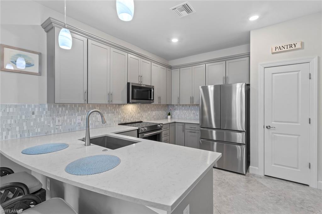 5825 Mayflower Way Ave Maria, FL 34142 - Photo 12 of 50 a kitchen with refrigerator and cabinets