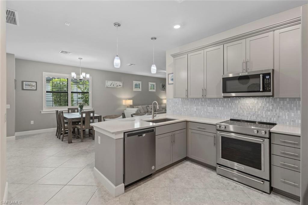 5825 Mayflower Way Ave Maria, FL 34142 - Photo 13 of 50 a kitchen with a sink stove and microwave