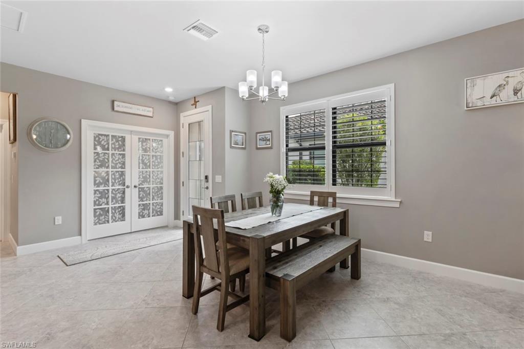 5825 Mayflower Way Ave Maria, FL 34142 - Photo 15 of 50 a room with chandelier furniture and windows