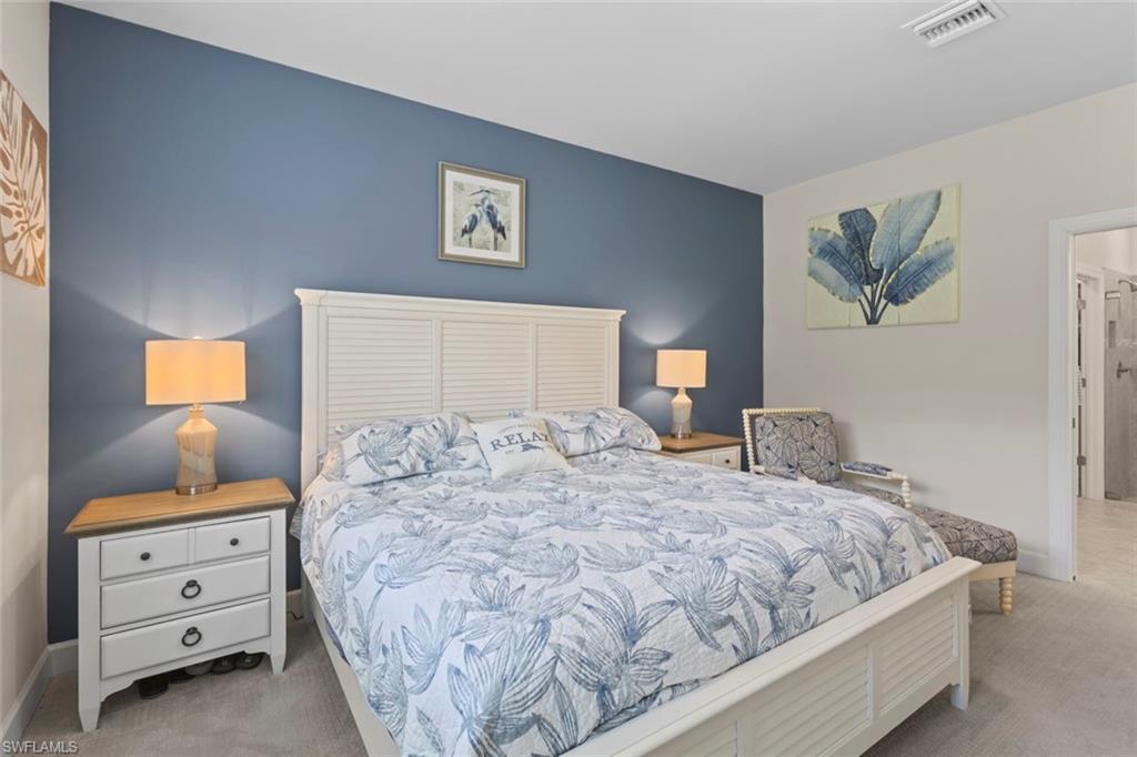 5825 Mayflower Way Ave Maria, FL 34142 - Photo 18 of 50 a bedroom with a bed and lamp on dresser