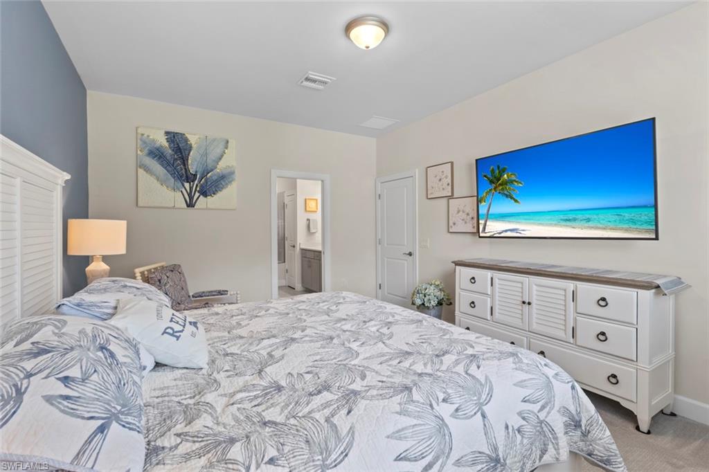 5825 Mayflower Way Ave Maria, FL 34142 - Photo 19 of 50 a bedroom with a bed and a window
