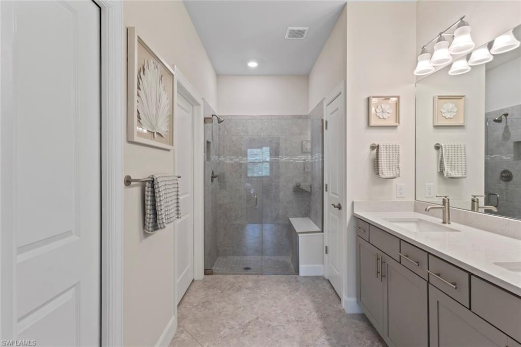 5825 Mayflower Way Ave Maria, FL 34142 - Photo 21 of 50 a spacious bathroom with a shower sink and mirror