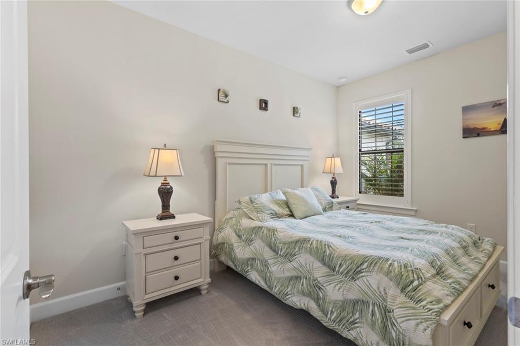 5825 Mayflower Way Ave Maria, FL 34142 - Photo 26 of 50 a bedroom with a bed and a night stand
