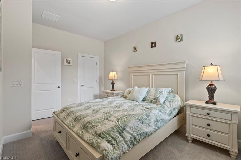 5825 Mayflower Way Ave Maria, FL 34142 - Photo 27 of 50 a bedroom with a bed and a dresser