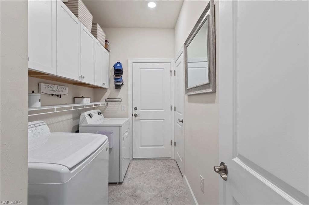 5825 Mayflower Way Ave Maria, FL 34142 - Photo 28 of 50 a kitchen with a sink and refrigerator