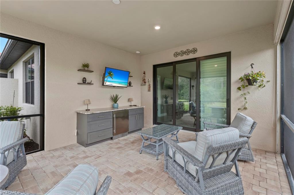 5825 Mayflower Way Ave Maria, FL 34142 - Photo 29 of 50 a living room with furniture a couch and a flat screen tv