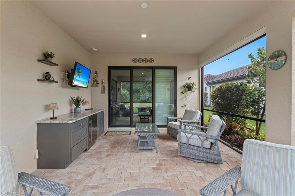 5825 Mayflower Way Ave Maria, FL 34142 - Photo 30 of 50 a living room with furniture and a flat screen tv