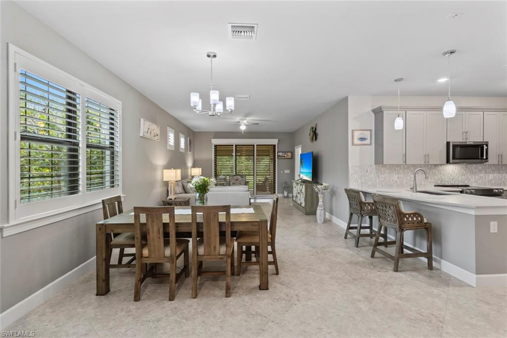5825 Mayflower Way Ave Maria, FL 34142 - Photo 3 of 50 a view of a dining room with furniture window and outside view