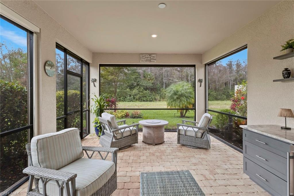 5825 Mayflower Way Ave Maria, FL 34142 - Photo 32 of 50 a living room with furniture and a garden