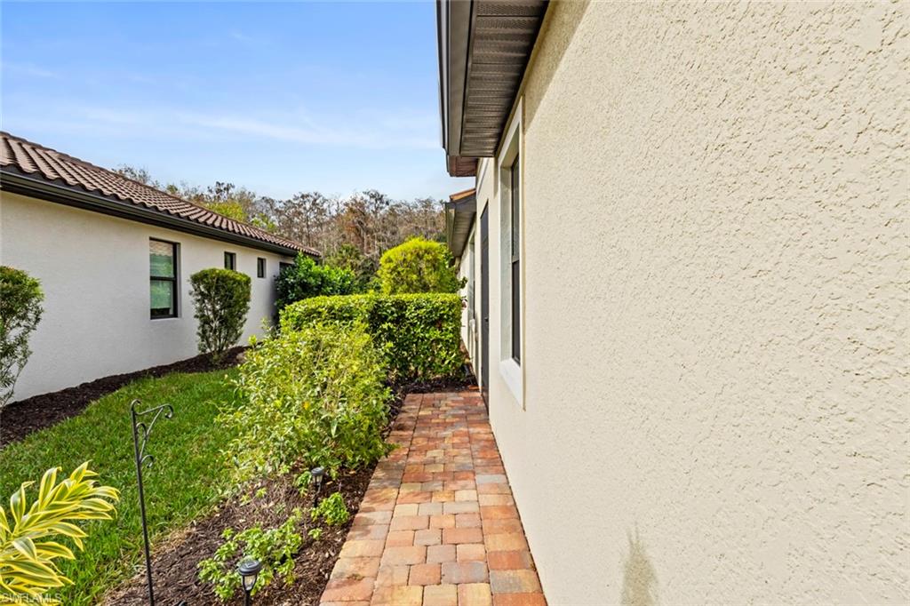 5825 Mayflower Way Ave Maria, FL 34142 - Photo 33 of 50 a view of a pathway both side of a house