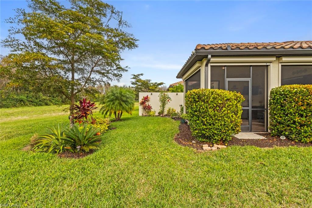 5825 Mayflower Way Ave Maria, FL 34142 - Photo 34 of 50 a front view of a house with garden